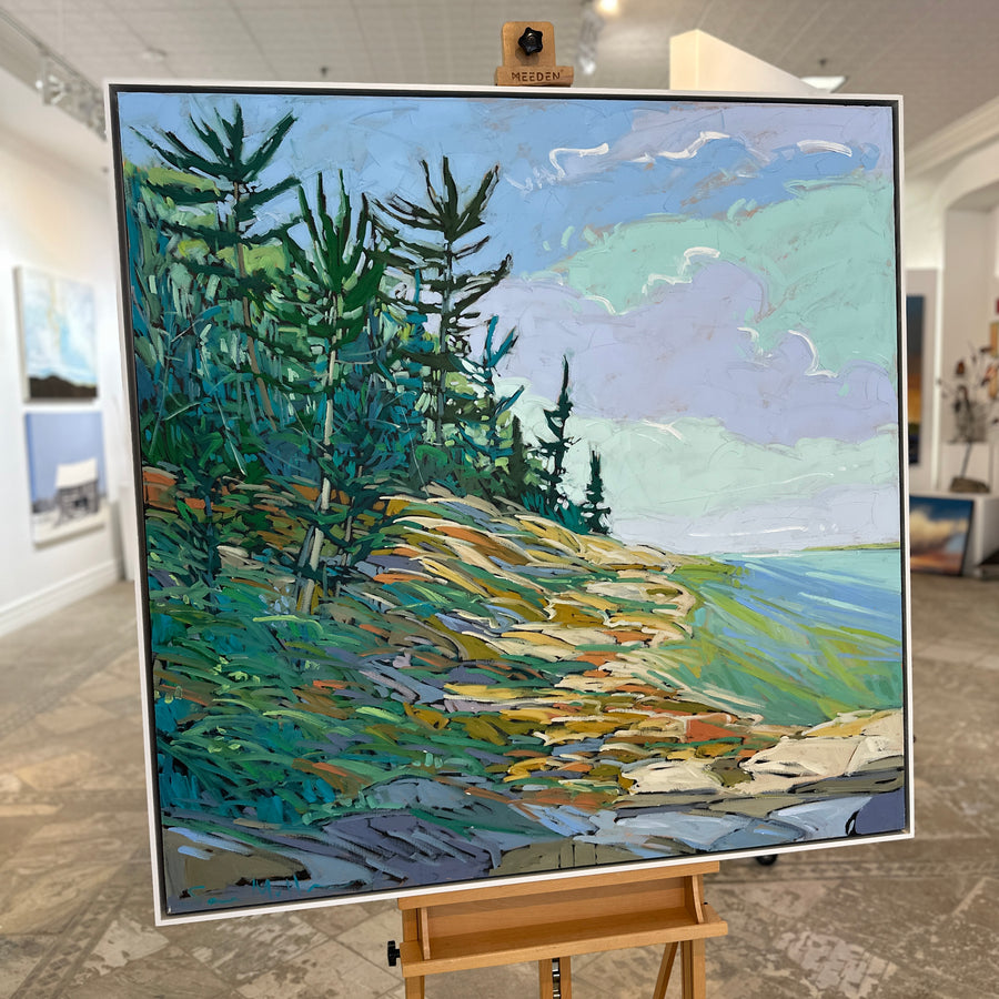The same landscape painting in a white floating frame, on an easel in Butter Gallery